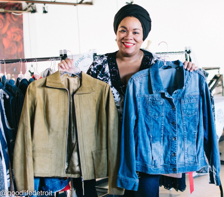 Woman stands with a light tan suede jacket and a denim jacket.
