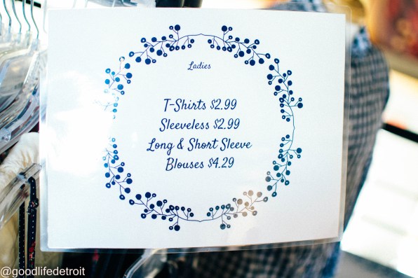 Pricing sign that reads T-Shirts $2.99, Sleeveless $2.99, Long & Short Sleeve Blouses $4.29